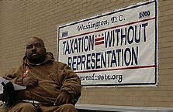 Bobby Coward sits near the D.C. license plate. Dozens attended the organizing event at the Martin Luther King Jr. Library, where they were urged to ask at least 10 people each to join today's rally and march to the U.S. Capitol.