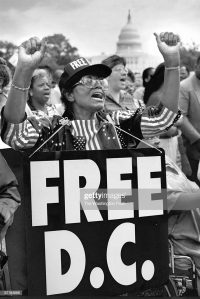 A &#039;Free DC&#039; rally on the Capitol grounds and March to the Hart Office Building to protest congressional denial of civil rights to District citizens. Protestor Loree H. Murray, 76, applauds speakers.