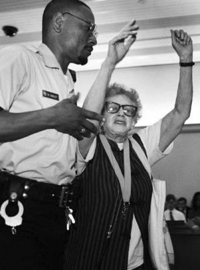 Winifred Gallant gets hauled out of the DC Council Chambers at One Judiciary Square after the convention center discussion vote.
